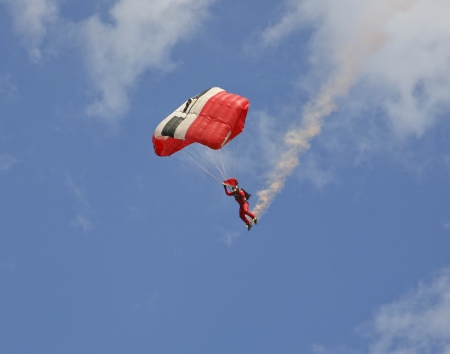 A skydiver trailing coloured smoke behind himのeditorial素材