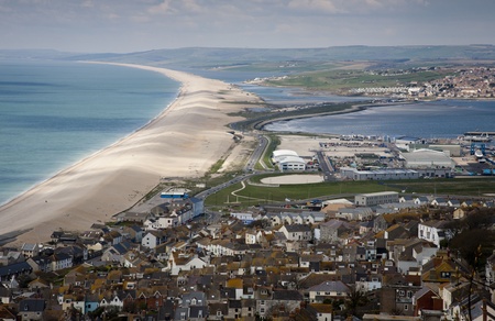 Hilltop view of Chesil beach, Dorset with the town of Fortuneswell in the foregroundの写真素材