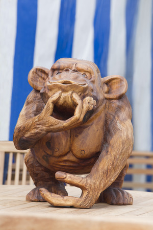 A humerous carving of a monkey made out of woodの写真素材