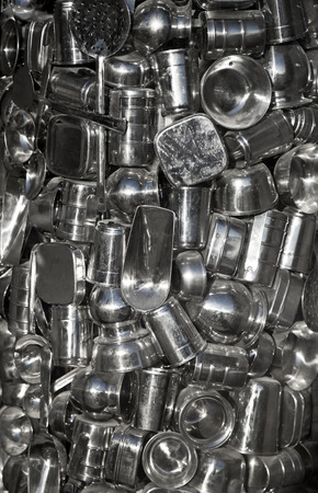 A large bottle holding a collection of various metal containersの写真素材