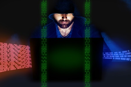 Man working at computer in dark empty room. Internet security conceptの写真素材