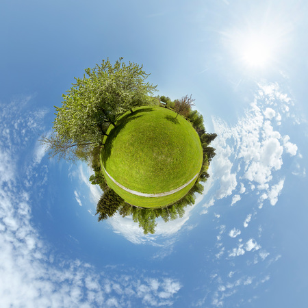 Little planet with trees, green meadow and blue skyの写真素材