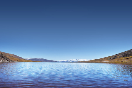 Crystal lake on the montains and blue sky backgroundの写真素材