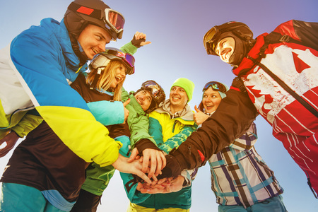 Bright color snowboarders stands on blue sky backdrop. Sheregesh, Siberia, Russiaの写真素材