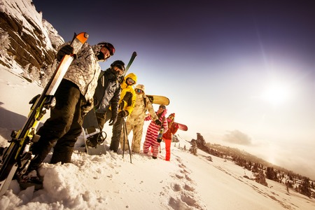 Bright color snowboarders posing on blue sky backdrop. Sheregesh, Siberia, Russiaの写真素材