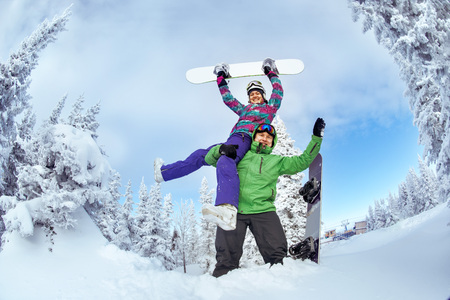 Bright color snowboarders posing on blue sky backdrop. Sheregesh, Siberia, Russiaの写真素材