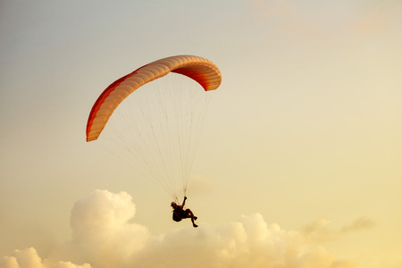 Skydiver flies on background of the cloudy sky backgroundの写真素材