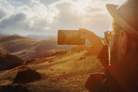Man taking photo of mountainsの写真素材