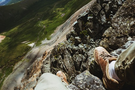 Mans legs on the top of mountain. First person viewの写真素材