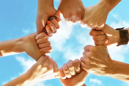 Hands ring teamwork on blue sky background