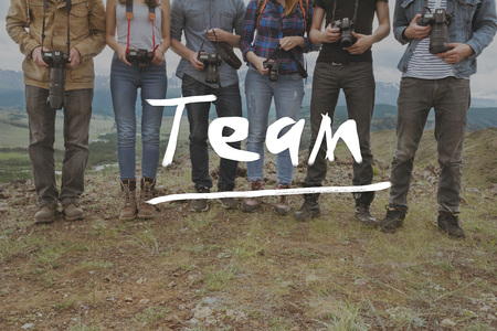 Team group of friends photographers on mountainds backdrop. Teamwork photography conceptの写真素材