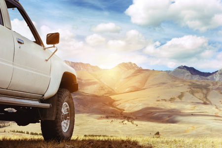 SUV car against mountains. 4x4 offroad concept. Space for text