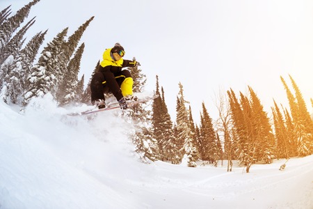 Snowboarder jumps in forest freeride backcountry skiing. Sheregesh ski resortの写真素材