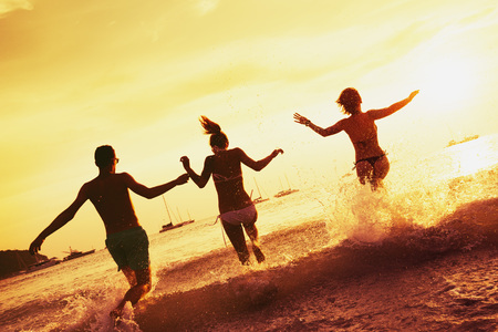 Happy friends sea sunset beachの写真素材