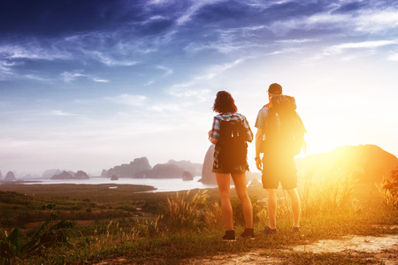 Two hikers backpackers view sunrise sunsetの写真素材