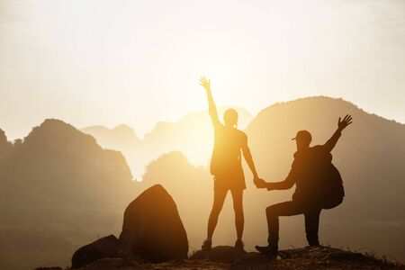 Couple backpackers hikers mountains sunsetの写真素材