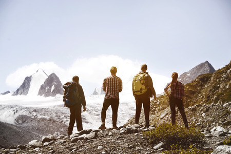 Group four friends trekking mountainsの写真素材