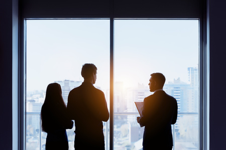 A couple and a real estate agent dealing by the window conceptの写真素材