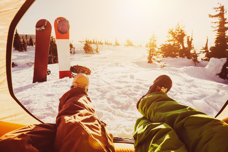Two friends snowboarders relaxing at tentの写真素材