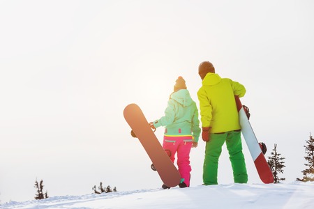 Two snowboarders stands with snowboardsの写真素材