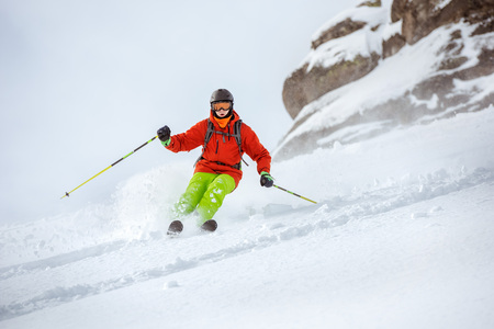 Skier freerides at offpiste slopeの写真素材
