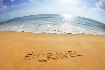 The word with hashtag "Travel" in the sand against the sea. Phuket island, Thailandの写真素材