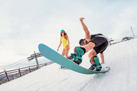 Young couple of snowboarders are having fun at ski resort. Winter holidays conceptの写真素材