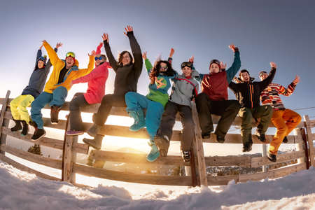 Group of happy friends skiers and snowboarders on holidays. Concept winter active sport weekend.の写真素材
