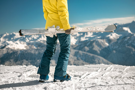 Closeup photo of girl standing with ski in hands. Ski weekend conceptの写真素材