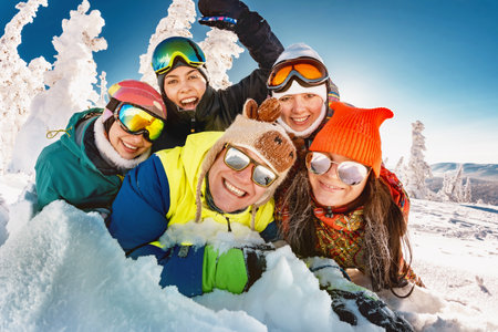 Group of happy young friends taking photo together. Winter vacations at ski resortの写真素材