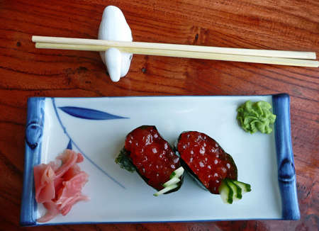 Japanese sushi with red caviar, ginger, wasabi and chopsticksの写真素材