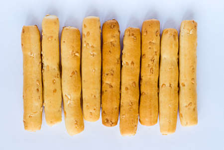Sesame seed breadsticks on whiteの写真素材