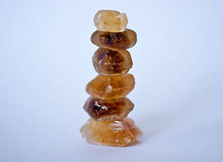 Pyramid of cane sugar cubes on white 