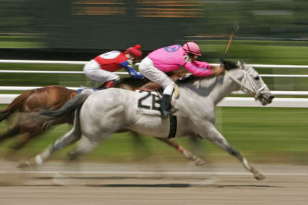 Slow shutter speed rendering of racing horses and jockeysの写真素材