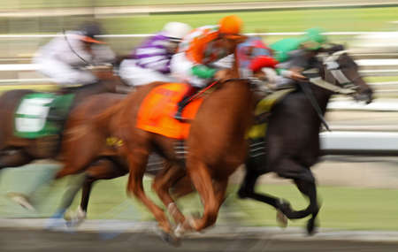 Slow shutter speed rendering of several racing jockeys and horsesの写真素材