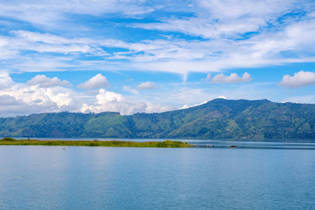 Scenic view of lake toba from Samosir in North Sumatra, Indonesia againts mountain and skyの写真素材