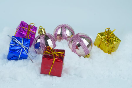 Glittered Christmas baubles with colorful presents with metallic strings. Selected focus.の写真素材