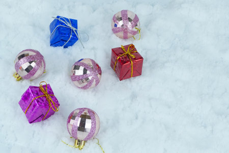 Glittered Christmas baubles with colorful presents with metallic strings. Selected focus.の写真素材