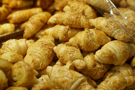 Sale of Cheese croissants and other pastries on the counter in the Supermarket in Surabaya,...