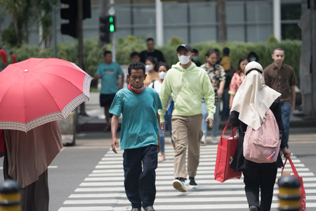 April 20, 2023. People crossing from the Transjakarta Bus Shelter. Jakarta, Indonesia.