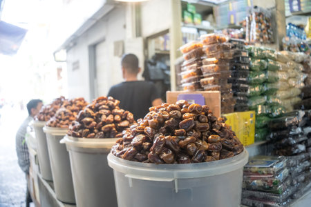 July 8. People in the market selling dates and assorted chickpeas near Mesjid Sunan Ample or Sunan Ample Mosque in Surabaya, Indonesia. Street Photography.のeditorial素材