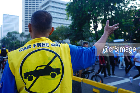 July 23, 2023. Jakarta, Indonesia. An attentive officer on duty, skillfully orchestrating traffic...