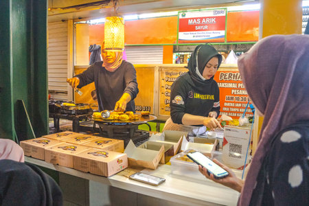 August 10, 2023. Activities at the traditional market called Oro Oro Dowo in Malang, East Java, Indonesia. The specialties are traditional foods such as cakes, beverages and others. Street Photography.のeditorial素材