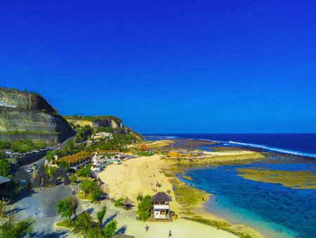 Melasti Beach, Bali is a tropical paradise. The white sand beach is nestled between two towering cliffs, and the turquoise waters are crystal clear.の写真素材