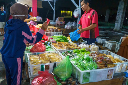November 24, 2023. Surabaya, Indonesia. Pasar Kue Subuh or Marketplace for snacks sold in the dawn time.のeditorial素材