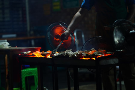 Grilled oyster at Jakarta Food Streets Vendor. Sizzling on a grill, plump oysters offering a taste...