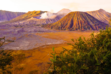 Dramatic sunrise over Mount Bromo, showcasing its volcanic cone and vast sand sea, creating a breathtaking landscape.の写真素材