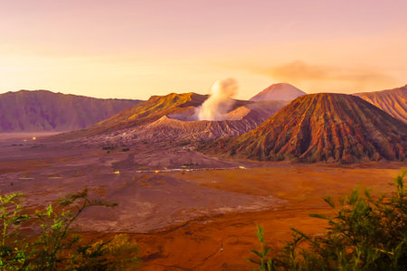 Dramatic sunrise over Mount Bromo, showcasing its volcanic cone and vast sand sea, creating a breathtaking landscape.の写真素材