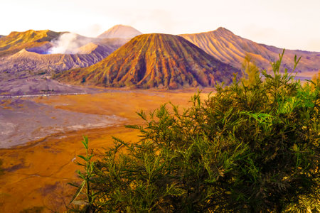 Dramatic sunrise over Mount Bromo, showcasing its volcanic cone and vast sand sea, creating a breathtaking landscape.の写真素材