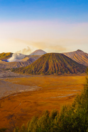 Dramatic sunrise over Mount Bromo, showcasing its volcanic cone and vast sand sea, creating a breathtaking landscape.の写真素材